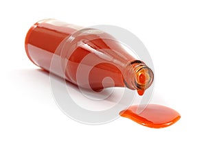 Hot sauce spilling from bottle photo