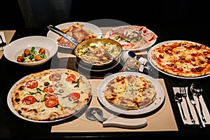 Hot served Italian dishes: Pizza Carbonara and Carpres with Pizza Cutter, Cold Cuts with Burrata Cheese.