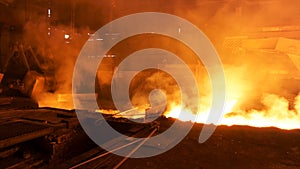 Hot shop at the metallurgical factory with molten steel in the chute. Stock footage. Metallurgical works, industrial