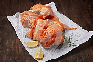 Hot smoked salmon fillet rolls on crumpled paper