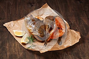 Hot smoked salmon`s heads on crumpled paper