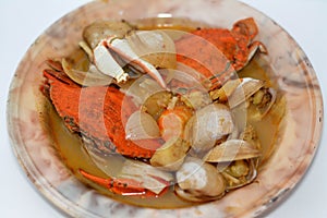 Hot soup meal of various fresh seafood marine crabs, shrimps, clams, mussels, gandofli, oysters, crab sticks, calamari, squid and