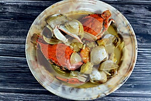 Hot soup meal of various fresh seafood marine crabs, shrimps, clams, mussels, gandofli, oysters, crab sticks, calamari, squid and