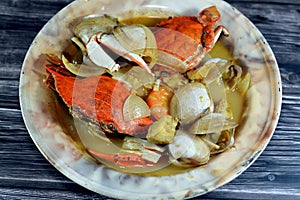 Hot soup meal of various fresh seafood marine crabs, shrimps, clams, mussels, gandofli, oysters, crab sticks, calamari, squid and