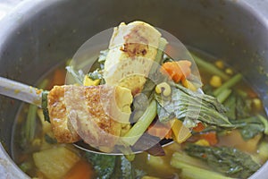 Hot and sour soup while cooking in stainless pot