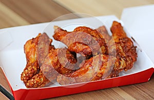 Hot and Spicey Buffalo Chicken Wings in cardboard delivery box photo