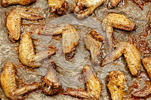 Hot and Spicey Buffalo Chicken Wings. Cooked chicken wings on parchment paper. Top view