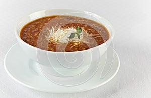 Hot and spicy beef soup with cheese in a bowl photo