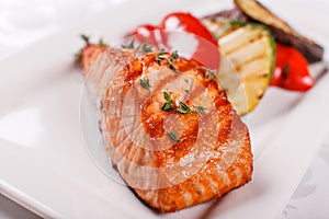 Hot and spicy fillet red fish. Grilled steak salmon or trout with grill paprika and zucchini. Healthy food, seafood and