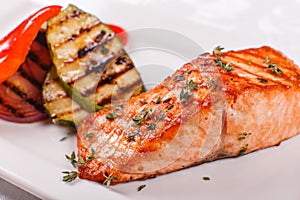 Hot and spicy fillet red fish. Grilled steak salmon or trout with grill paprika and zucchini. Healthy food, seafood and