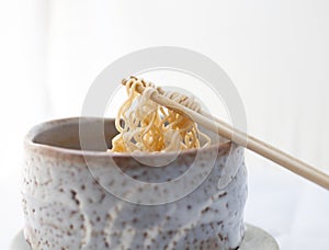 Hot and spicy instant noodle in clay bowl.