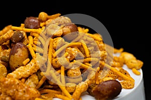 Hot spicy NavRatan mixture snacks in full-frame, made with, potato chips, peanuts, besan sev spicy snacks (Namkeen)