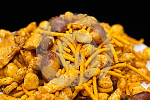 Hot spicy NavRatan mixture snacks in full-frame, made with, potato chips, peanuts, besan sev spicy snacks (Namkeen)