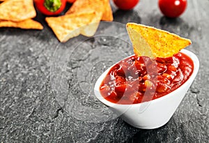Hot spicy salsa sauce with corn tortillas photo