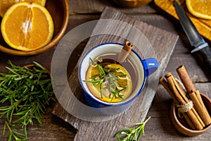 Hot spicy warming herbal tea in blue cup. Tea with orange and rosemary. Wide banner for web sites background.  Selective focus,