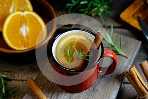 Hot spicy warming herbal tea in red cup. Tea with orange and rosemary. Wide banner for web sites background.  Selective focus,