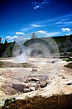 Hot springs on a dark blue sky backdrop in Yellowstone National Park, US
