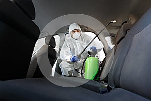 Hot steam disinfection of car seats in coronavirus hazmat photo