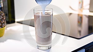 Hot, steamed milk being poured in glass with coffee, stock footage by Brian Holm Nielsen