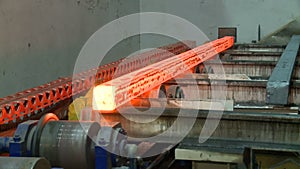 Hot steel ingots on conveyor. Foundry casting process