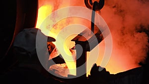 Hot steel pouring at steel plant. Stock footage. Flowing metal at the foundry. Pouring of liquid metal in open hearth