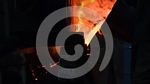 Hot steel pouring at steel plant. Stock footage. Flowing metal at the foundry. Pouring of liquid metal in open hearth