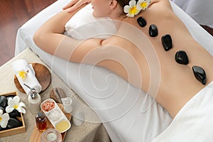 Hot stone massage at spa salon in luxury resort. Quiescent