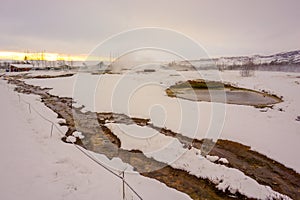 Hot Stream In A Snow Covered Landscape With Steaming Water