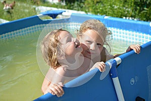 On a hot summer day, children relax on the lake. Girls on the beach. People frolic in the water.