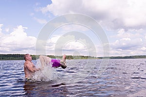 On a hot summer day, children relax on the lake. Girls on the beach. People frolic in the water.