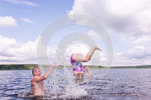 On a hot summer day, children relax on the lake. Girls on the beach. People frolic in the water.