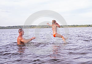 On a hot summer day, children relax on the lake. Girls on the beach. People frolic in the water.