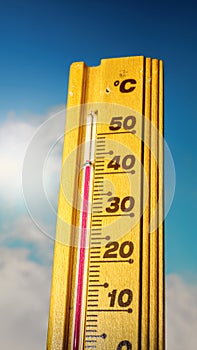 Hot summer day, the thermometer displays a high heatwave temperature