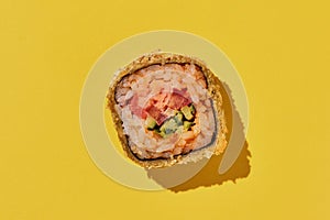 Hot sushi roll with shrimp on yellow background