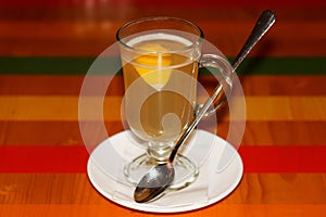 Hot sweet ginger tea with lemon, served in kafe