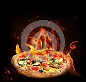 Hot tasty pizza with fire flames on background. Image for menu or poster