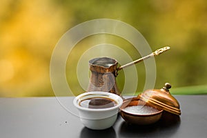 Hot tasty steaming coffee brewed in traditional turkish coffee pot