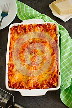 Hot tasty vegetable and cheese lasagna in ceramic casserole dish