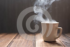 Hot tea / coffee in a mug on a wooden table background