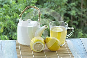 Hot tea cup with lemon and Teapot