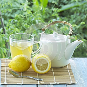 Hot tea cup with lemon and Teapot