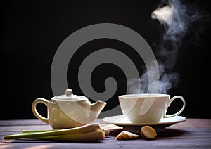 Hot tea cup and teapot on wood background. Hot drink .