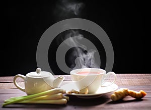 Hot tea cup and teapot on wood background. Hot drink .