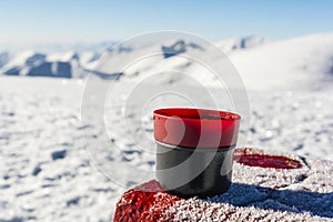 Hot tea in a cup from a thermos on the table with a boundary mar