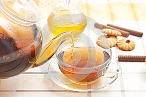 Hot tea flowing from teapot