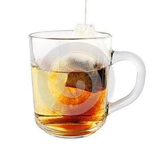 Hot tea in glass mug with packet