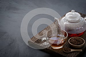 Hot tea in a glass teapot and cup