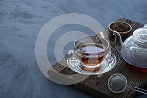 Hot tea in a glass teapot and cup