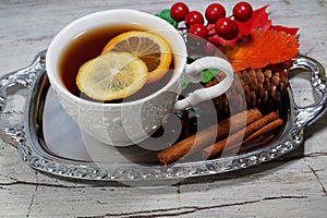 Hot tea with lemon in autumn and winter evenings - a festive table