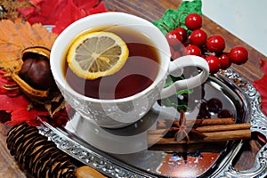 Hot tea with lemon in autumn and winter evenings - a festive table